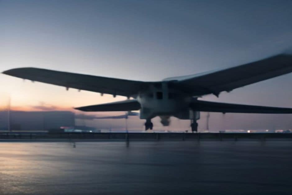 Modern regional airport terminal with an electric aircraft charging station and cable at dusk